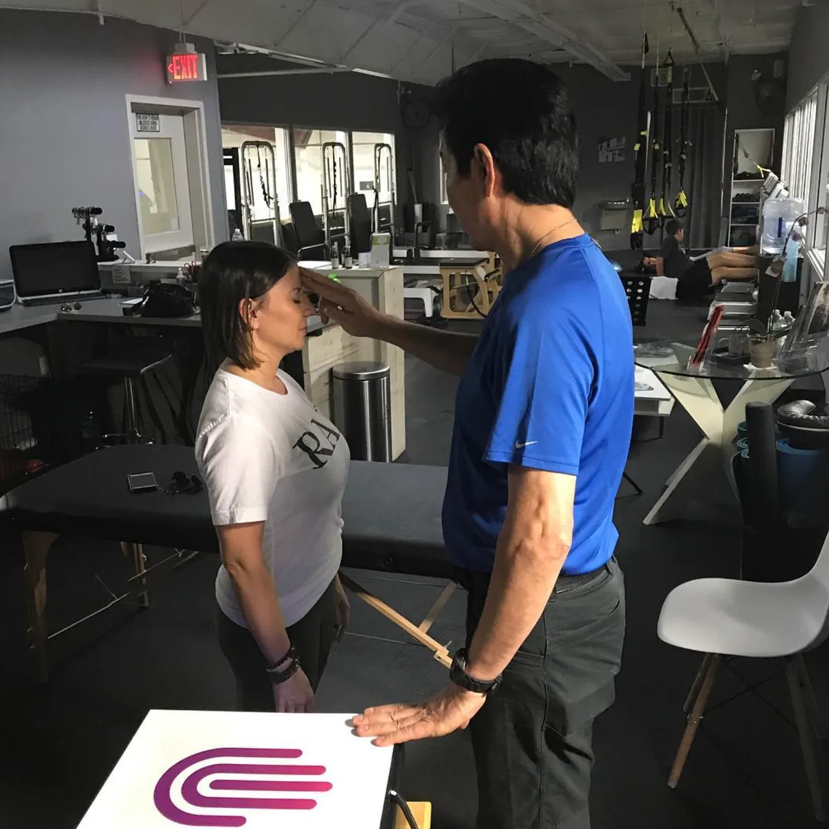 An Electrons Plus practitioner performing a muscle test on a client in a clinic